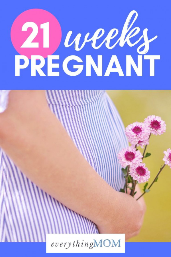 21 weeks pregnant woman with flowers