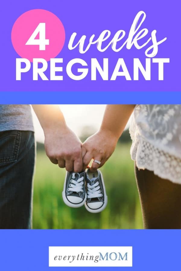 4 weeks pregnant holding baby shoes