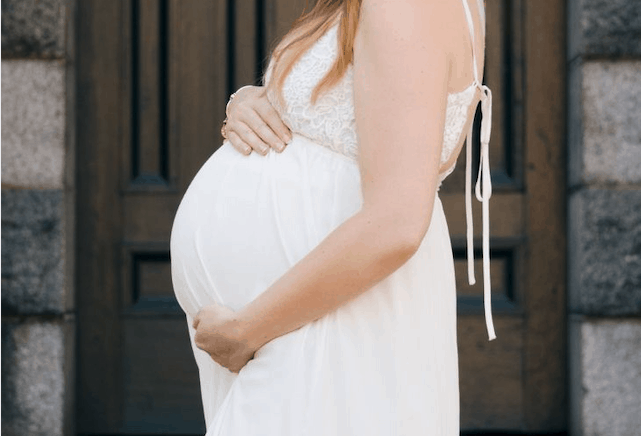 woman pregnant in white dress