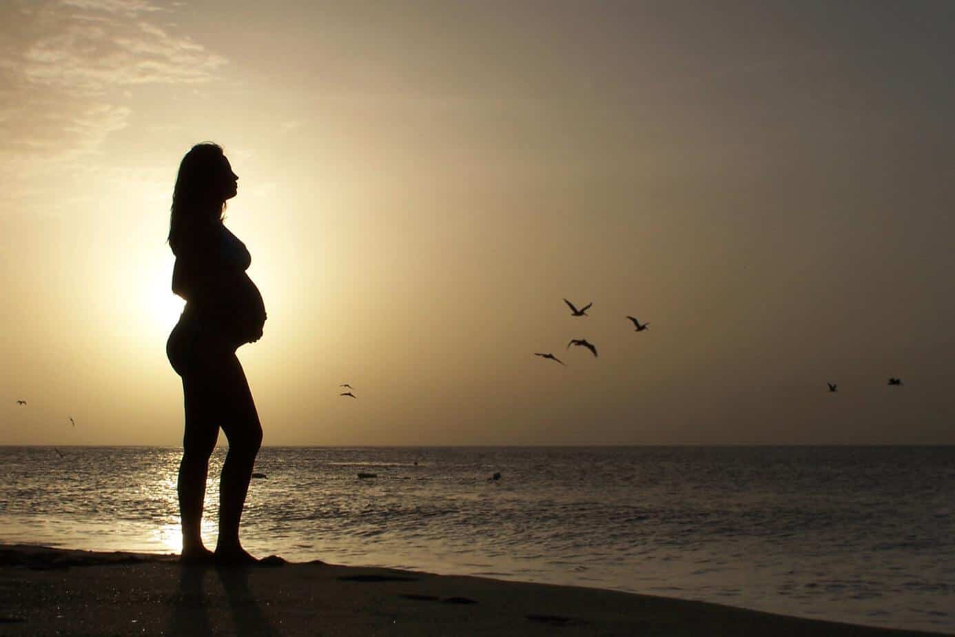 20 weeks pregnant sunset woman beach