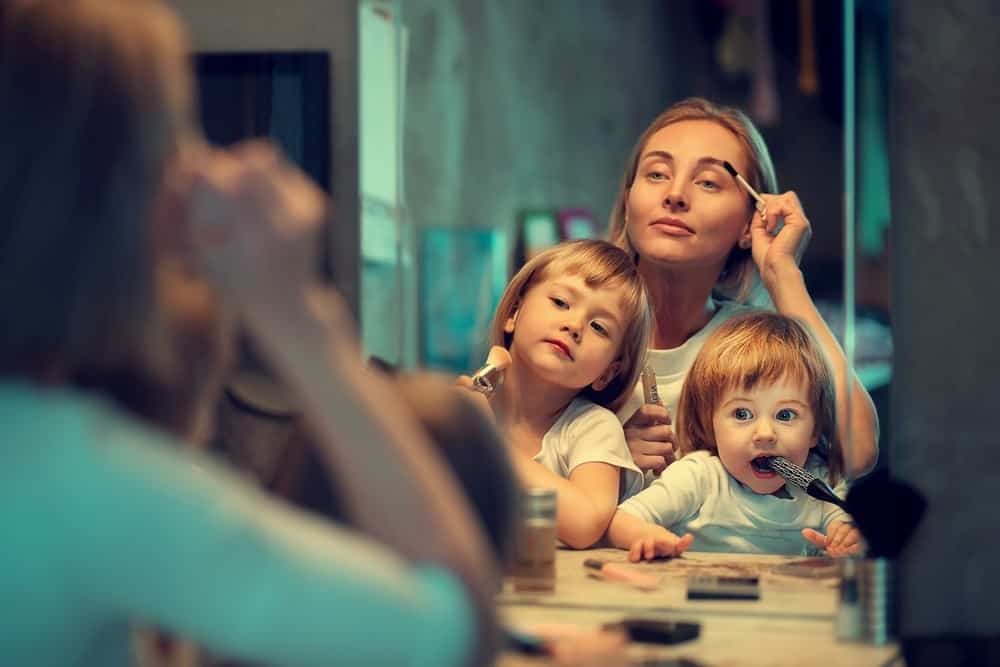 young mom applying simple makeup