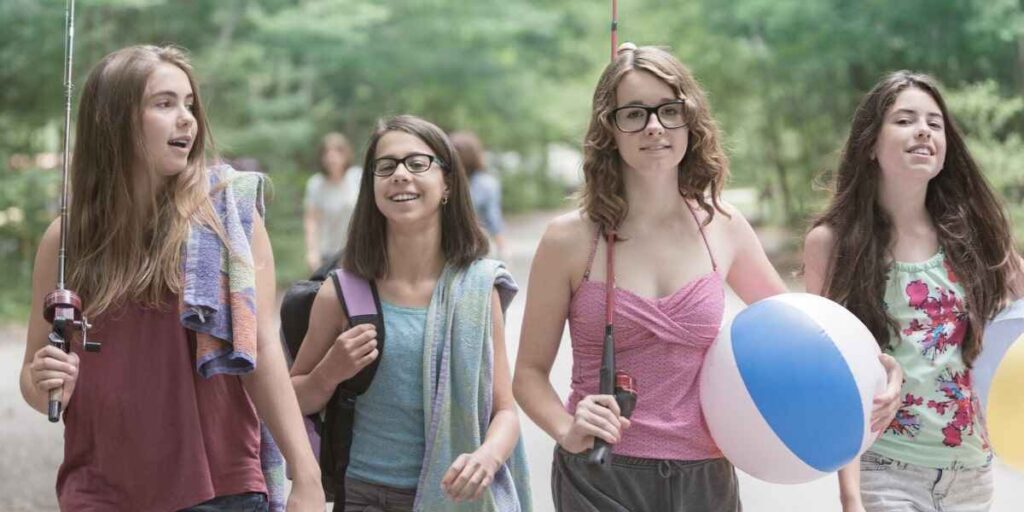 older teen girls practicing mindfulness games as a group.